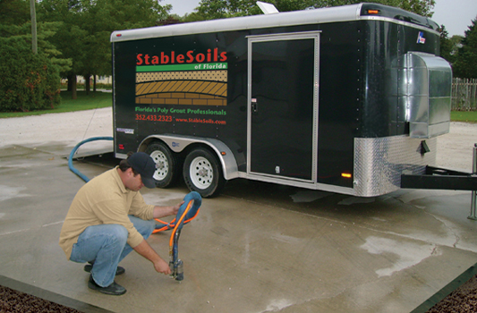 A man repairing a concrete driveway