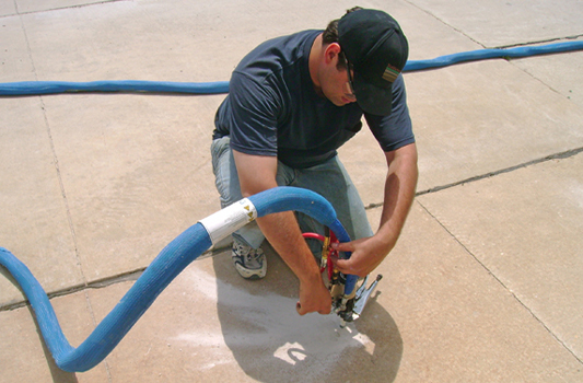 Man repairing a concrete driveway